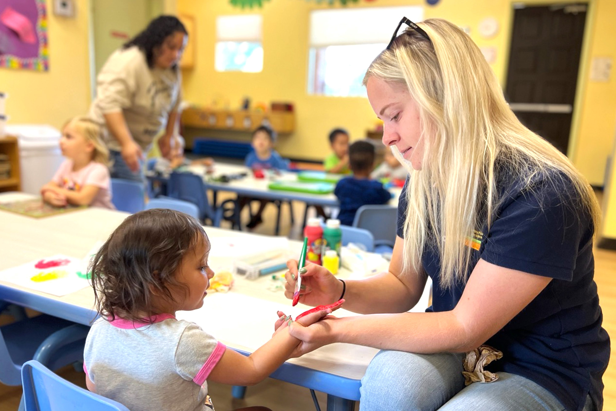 Teacher supporting learning in a Pre-K childcare setting