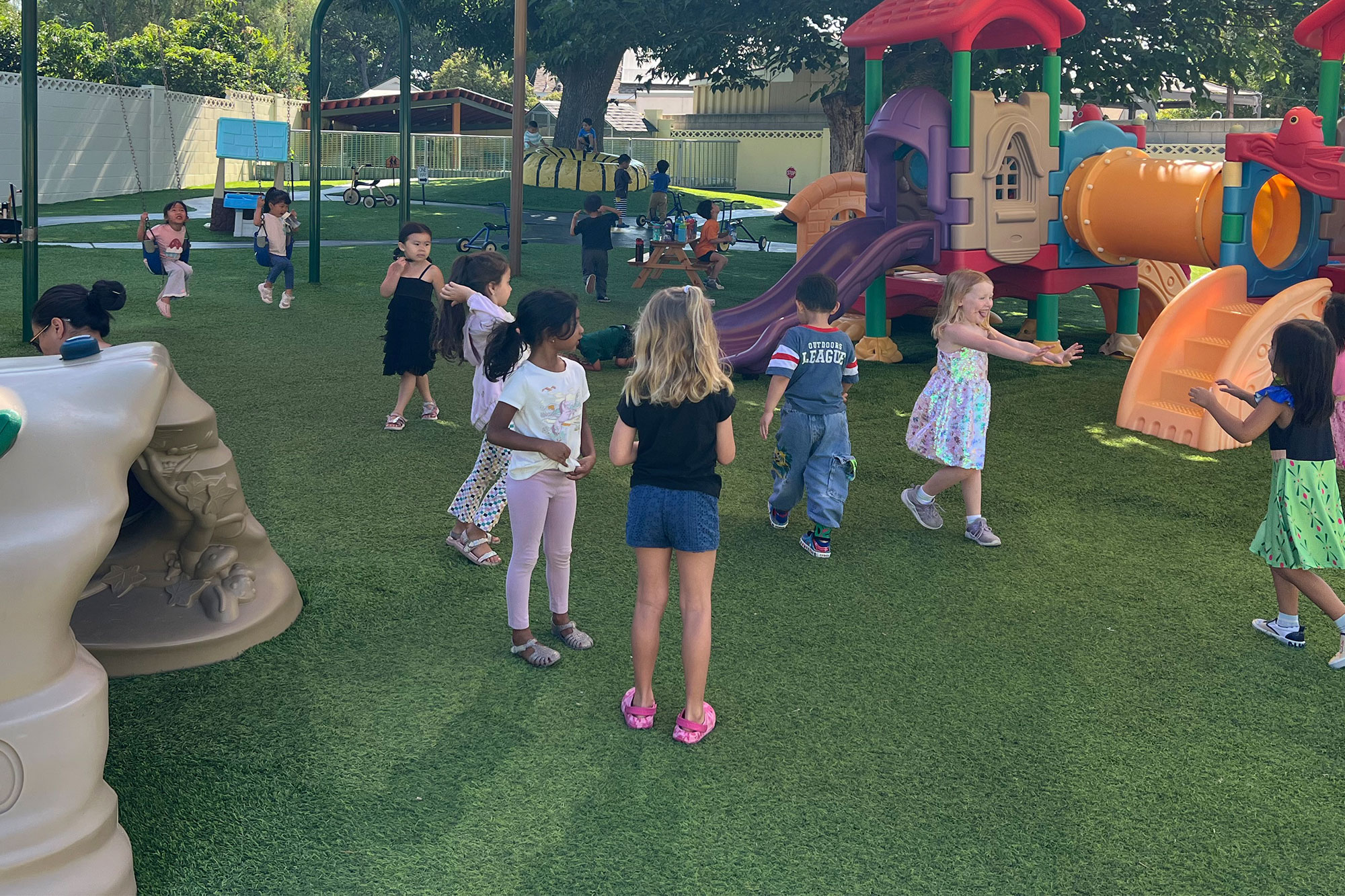 Young children playing in an outdoor play area at a Placentia preschool